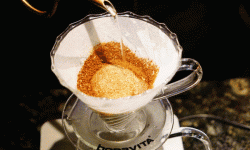 Senior instructor demonstrates hand-made coffee, speed onlookers!